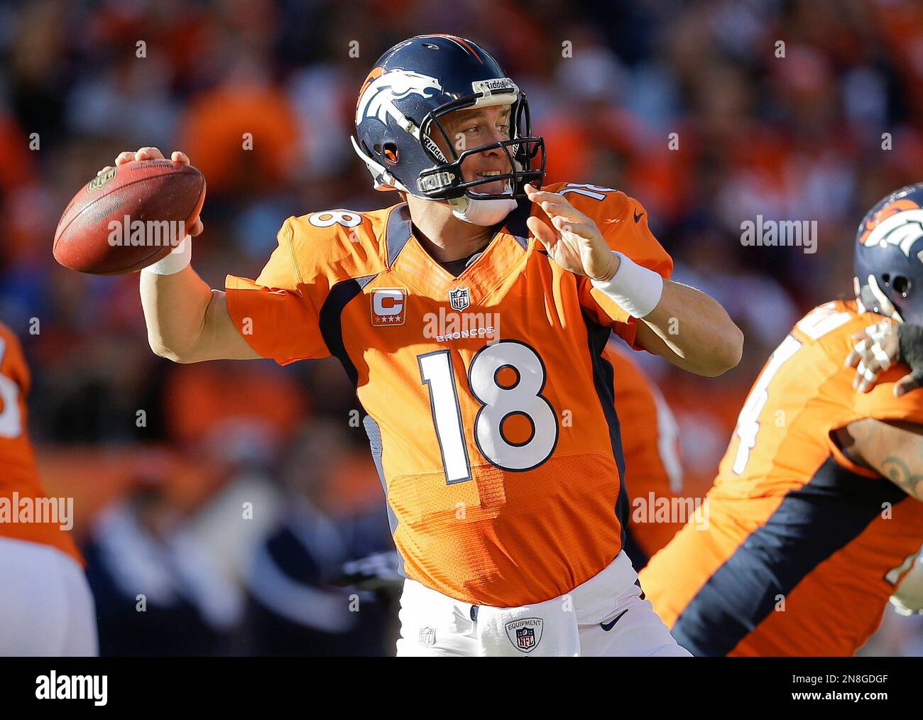 Denver Broncos quarterback Peyton Manning (18) sets to throw a pass ...