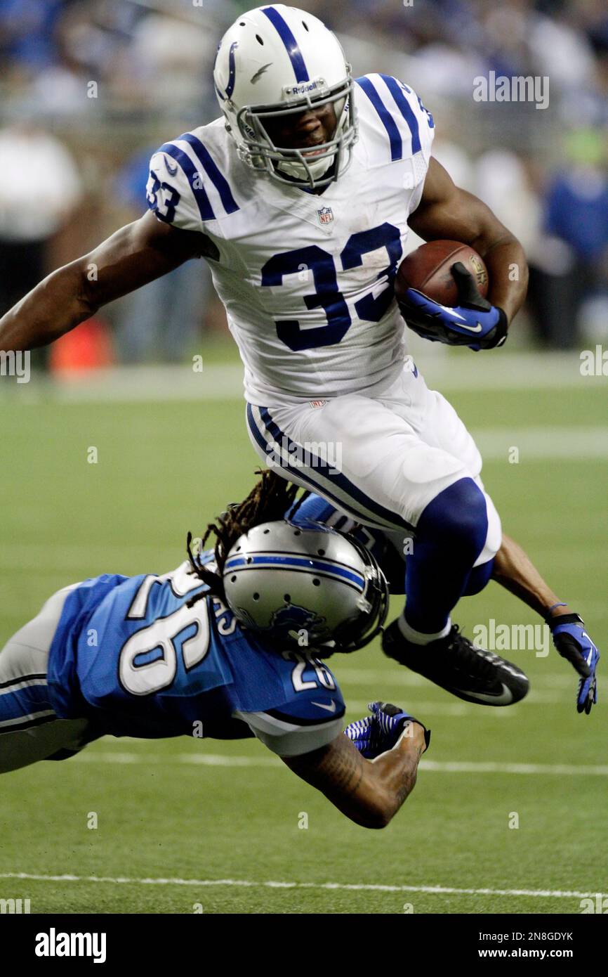 Indianapolis Colts running back Vick Ballard (33) jumps over Detroit Lions safety Louis Delmas (26) enroute to the end zone and a touchdown during the third quarter of an NFL football game at Ford Field in Detroit, Sunday, Dec. 2, 2012. (AP Photo/Duane Burleson) Stock Photo