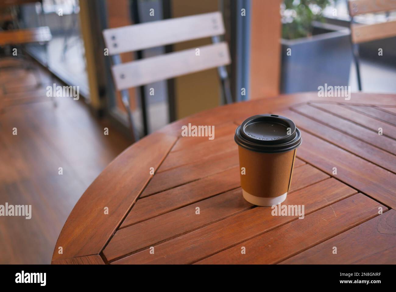 take away paper coffee cup o on cafe table Stock Photo - Alamy