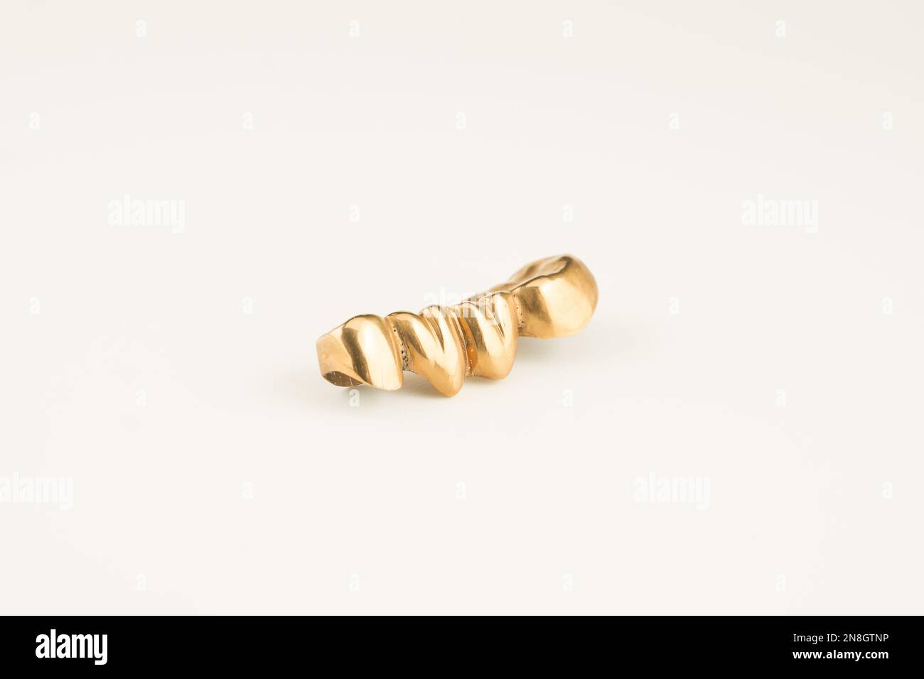 dental metal gold bridge isolated on white background Stock Photo - Alamy, image size:1300x956
