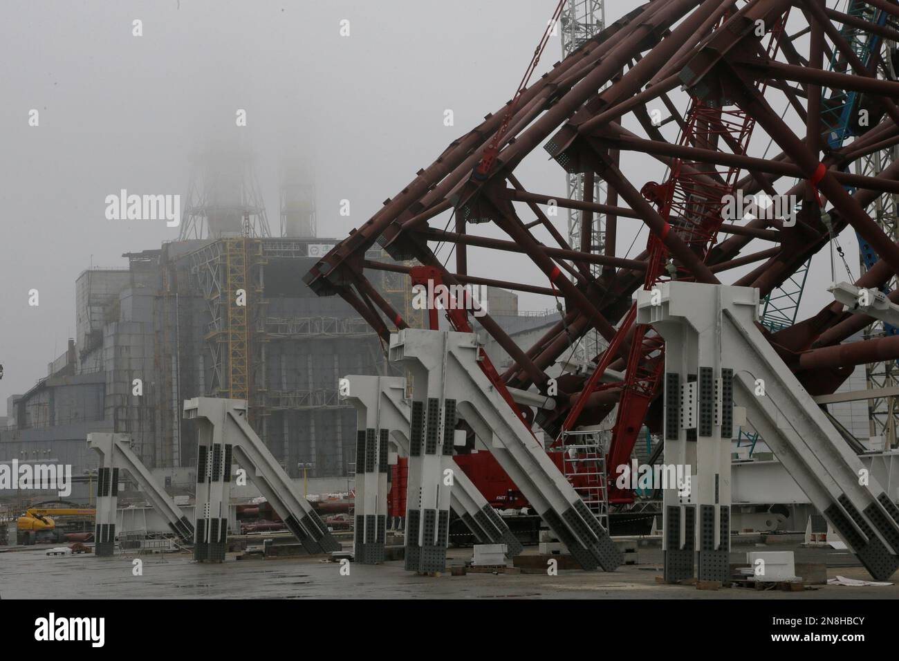 Construction workers assist in the assembly of a gigantic steel-arch to ...