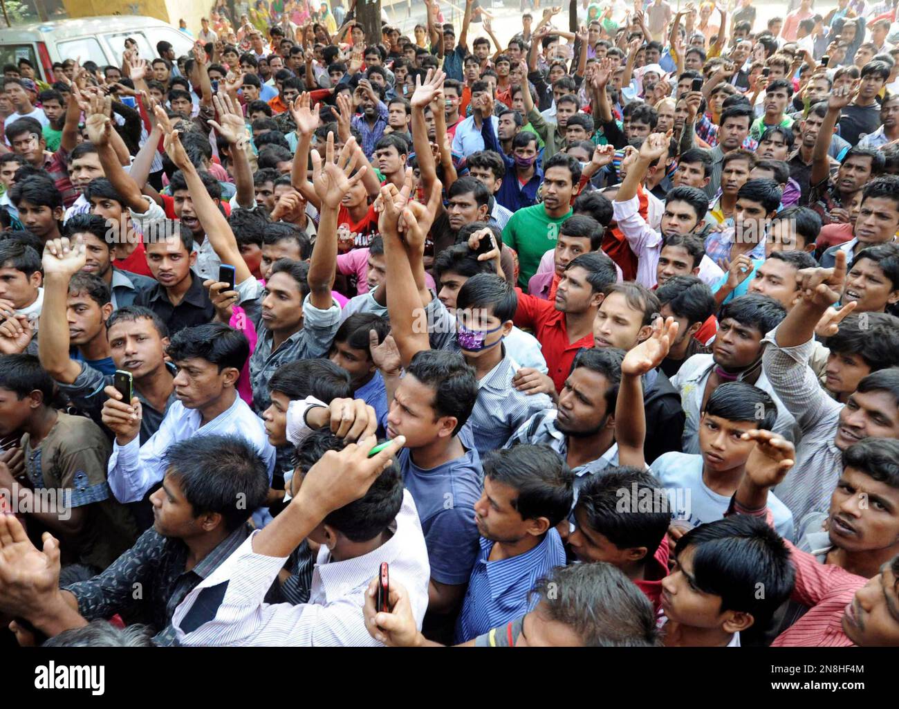 Bangladeshis protest outside a garment-factory where a fire killed more ...