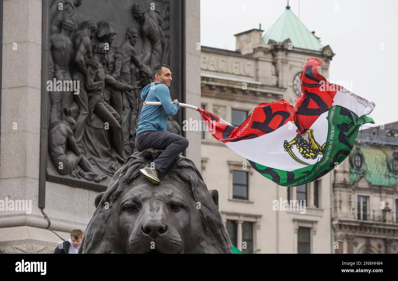 Man on lion with Iranian Flag Iran Woman Life Freedom protest Trafalgar Square London Stock Photo