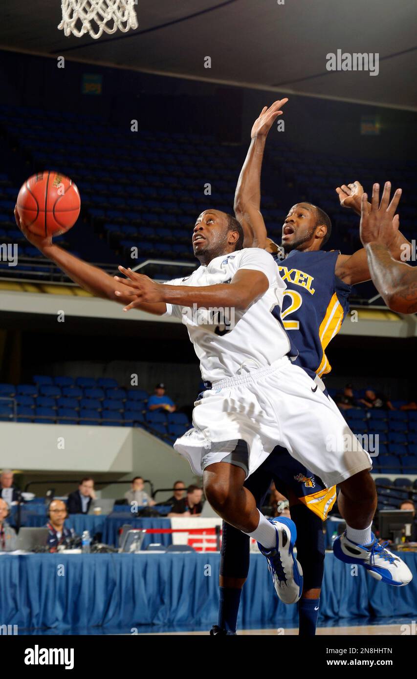 Rice's Tamir Jackson (3) shoots as Drexel's Derrick Thomas defends