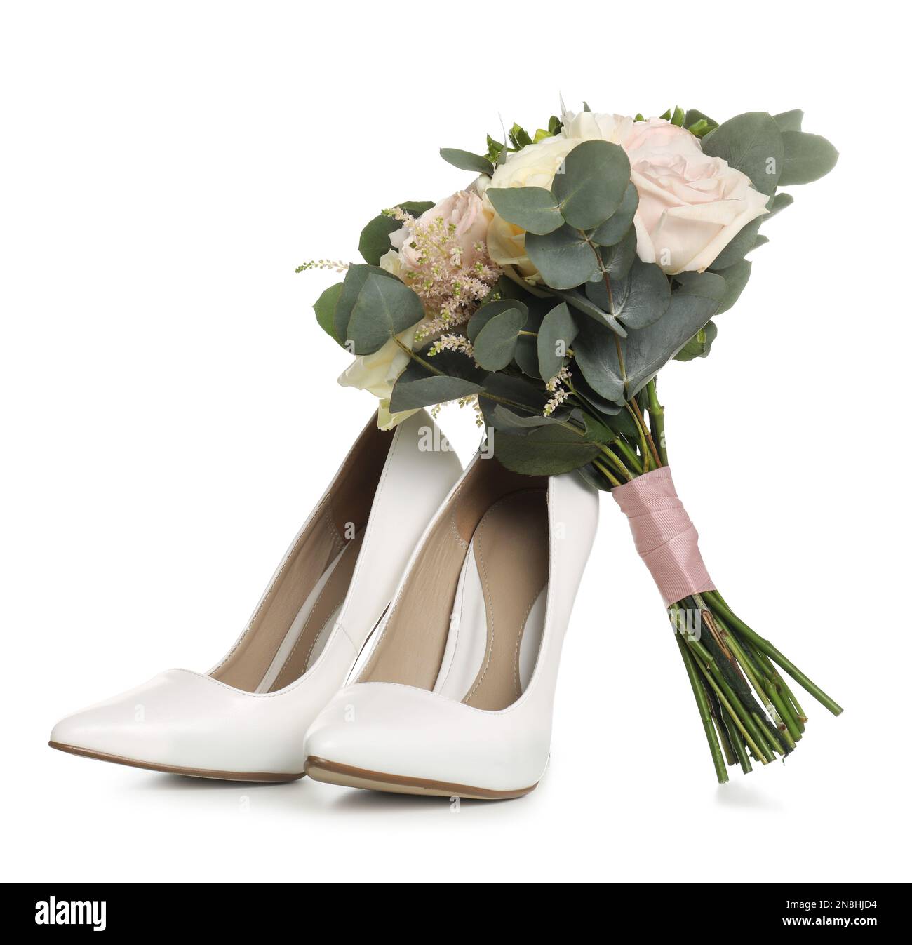 Pair of wedding high heel shoes and beautiful bouquet on white background Stock Photo