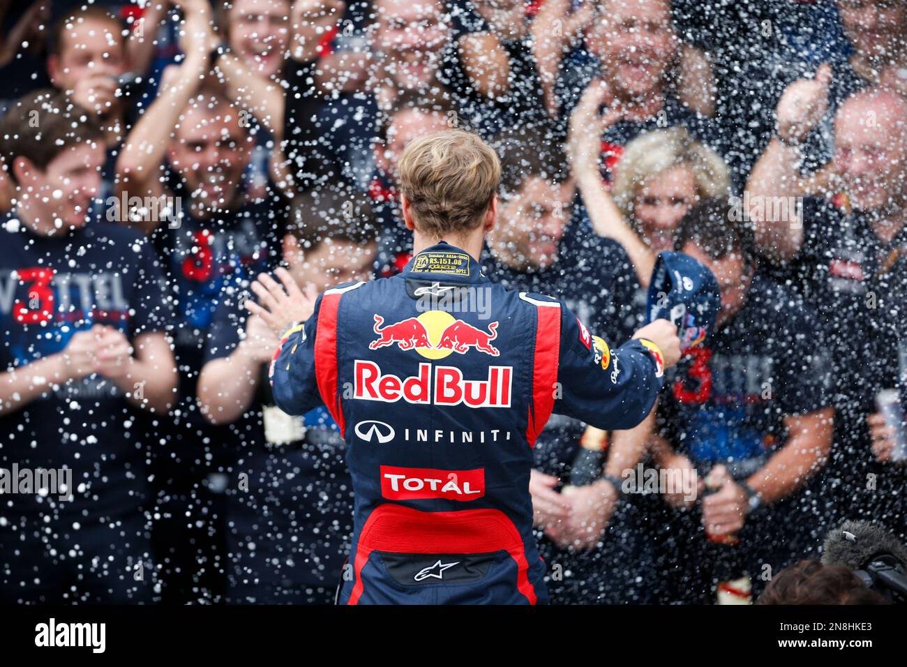 Red Bull driver Sebastian Vettel of Germany, center, is sprayed with  champagne after vowing to his team in celebration after the Brazil's  Formula One Grand Prix at the Interlagos race track in