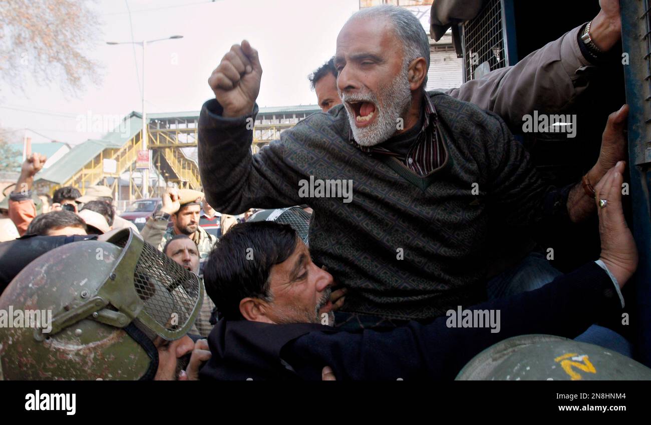 A Kashmiri Shiite Muslim shouts slogans as he is detained along with ...
