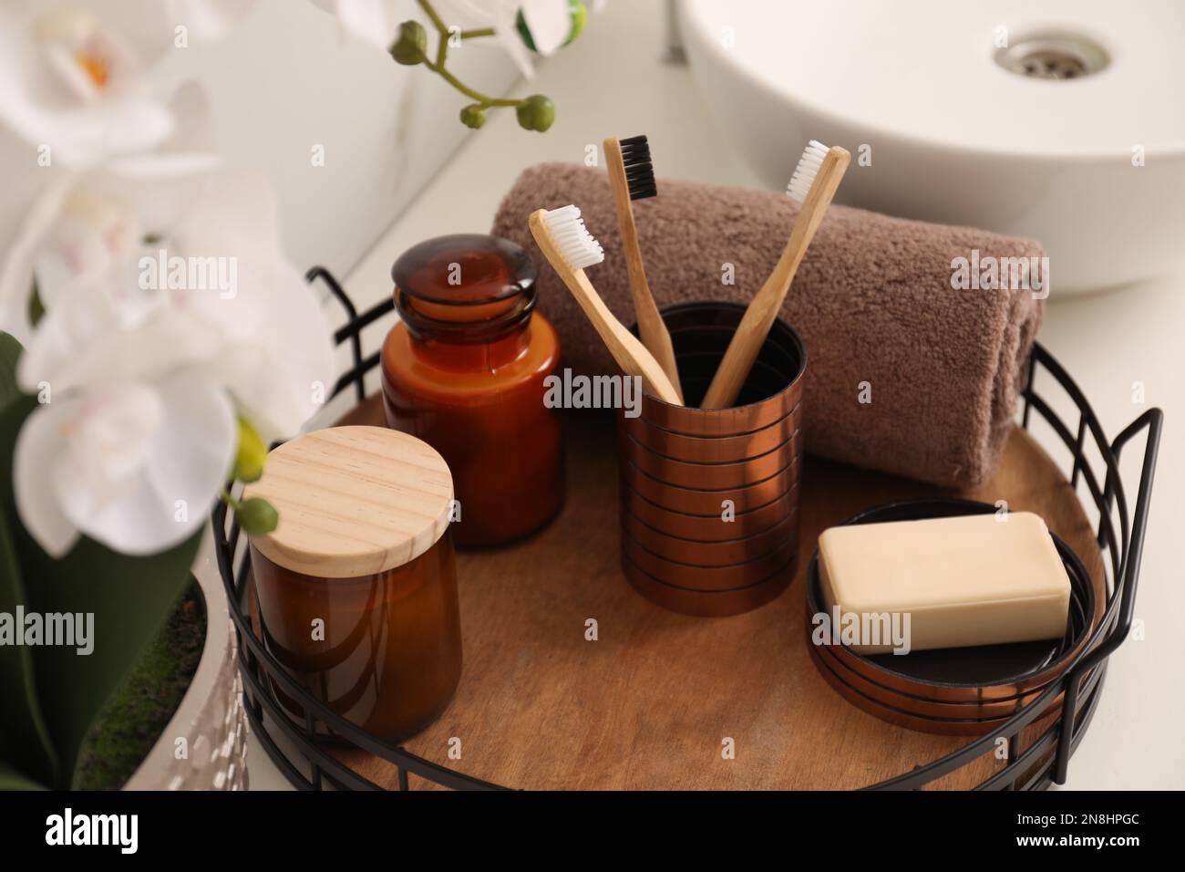 Tray with different toiletries on countertop in bathroom Stock Photo