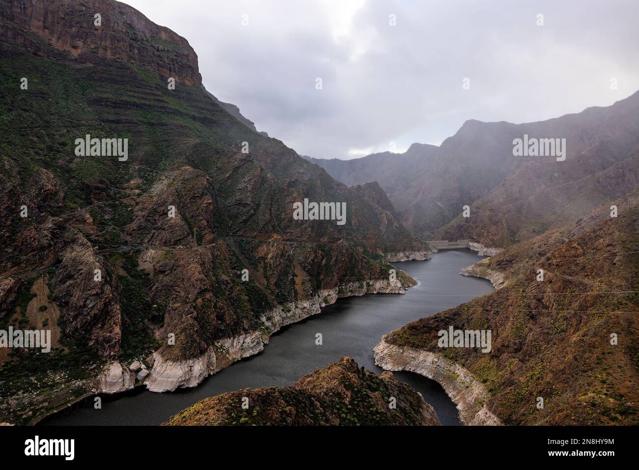 The river between two mountains on cloudy day with low clouds. Landscape photo with no people. Stock Photo