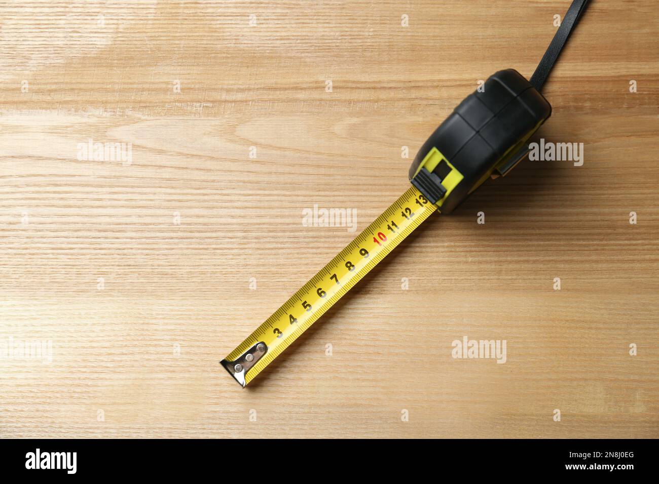 Top view of white soft measuring tape. Minimalist flat lay image