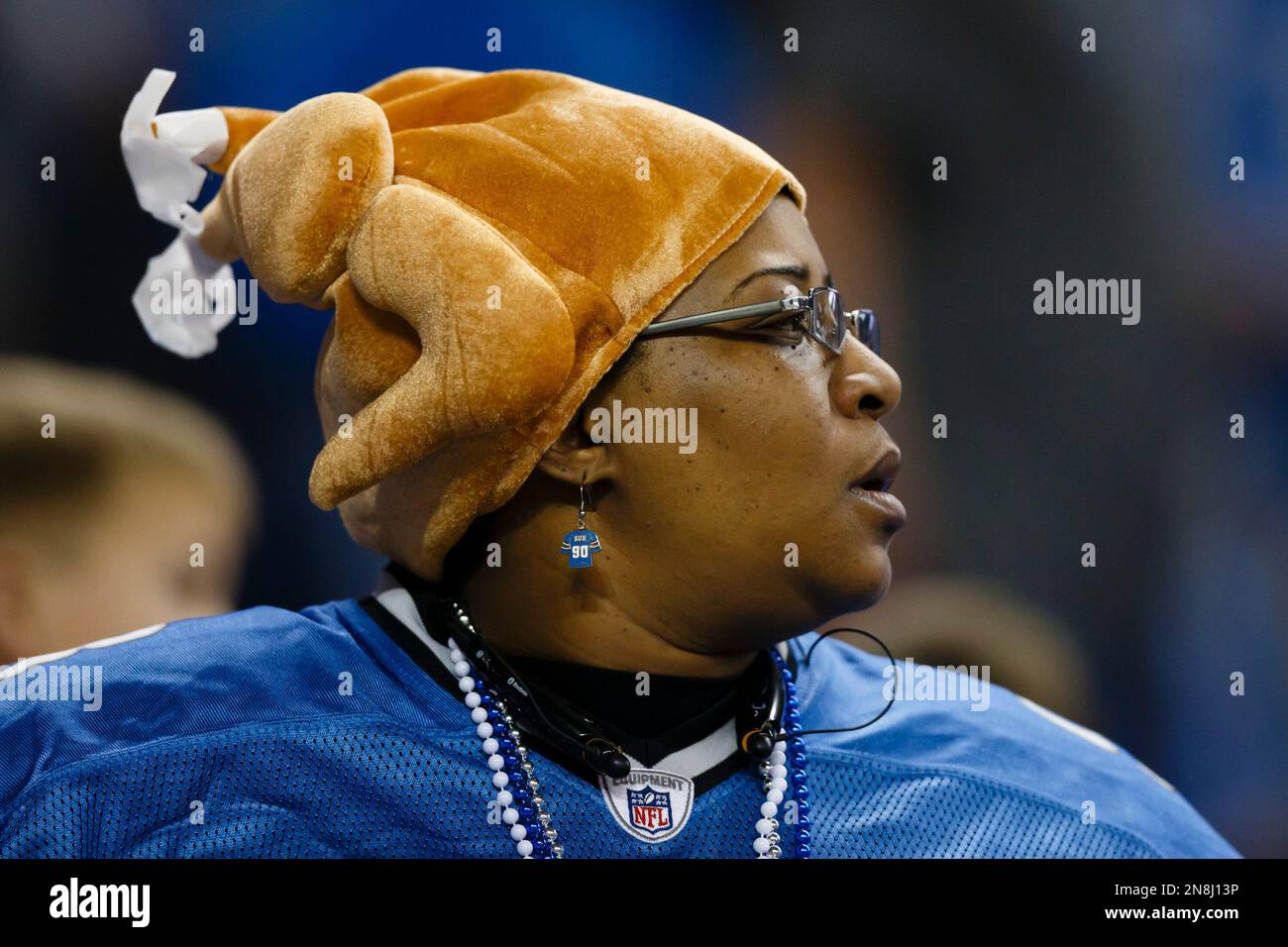 A Detroit Lions fan wears a turkey hat for Thanksgiving during an NFL  football game against the Houston Texans at Ford Field in Detroit,  Thursday, Nov. 22, 2012. (AP Photo/Rick Osentoski Stock