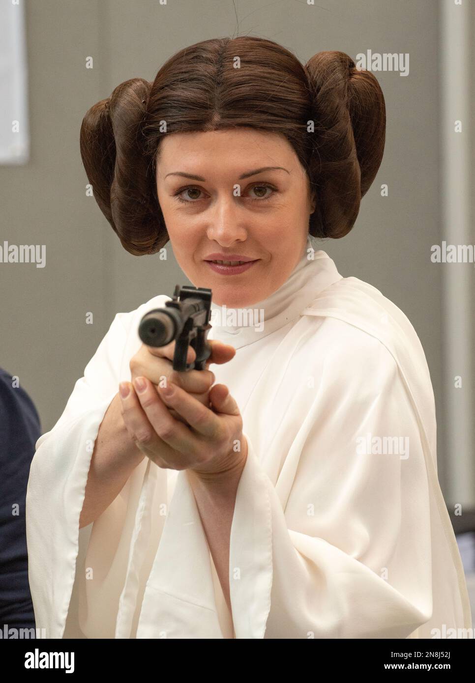 Cosplaying young woman dressed as Princess Leia character from the film Star Wars at the London Film Comic Con, held at Olympia London event venue. Stock Photo