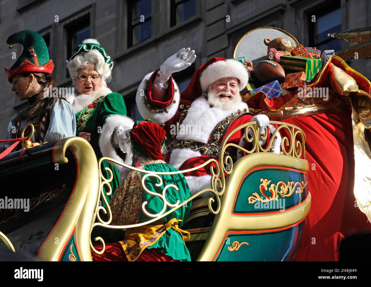 Santa and Mrs. Claus wave to the crowd at Herald Square during the 86th