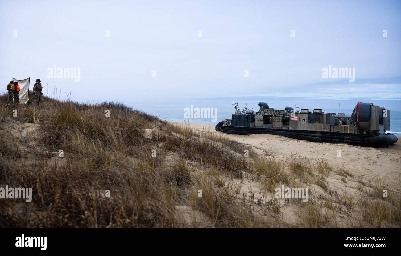 A U.S. Navy Landing Craft Air Cushion with Assault Craft Unit Four, lands on a beach during an amphibious exercise on Joint Expeditionary Base Little Creek-Fort Story, Virginia, Jan. 30, 2023. The exercise serves as an opportunity for stronger naval integration between Marines and Sailors by providing them with a better understanding of boarding and amphibious shipping. (U.S. Marine Corps photo by Lance Cpl. Ethan Robert Jones) Stock Photo