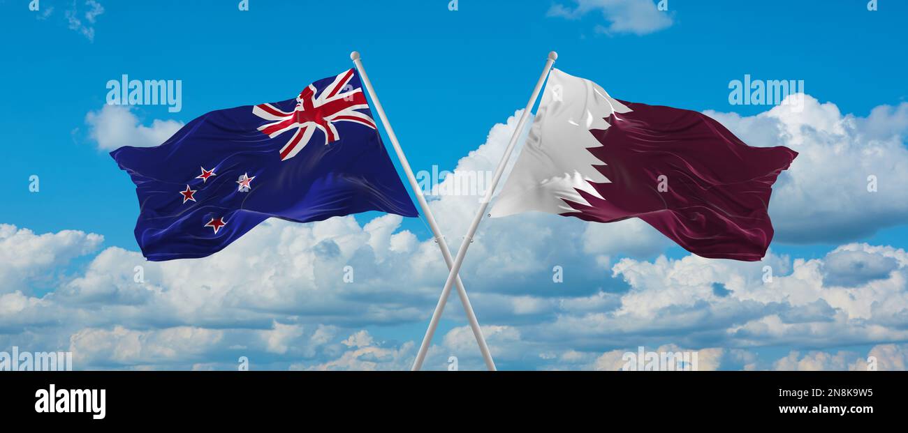 two crossed flags Qatar and New Zeeland waving in wind at cloudy sky ...