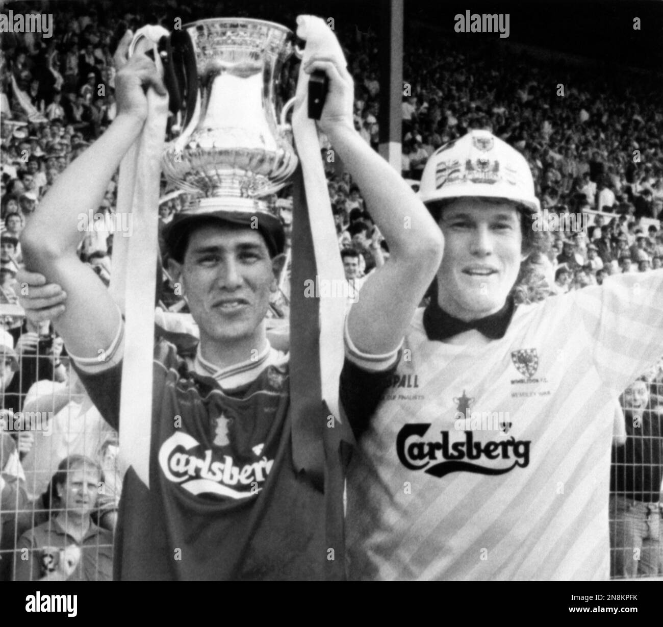 Wimbledon FC soccer player Lawrie Sanchez, holds the FA Cup as captain