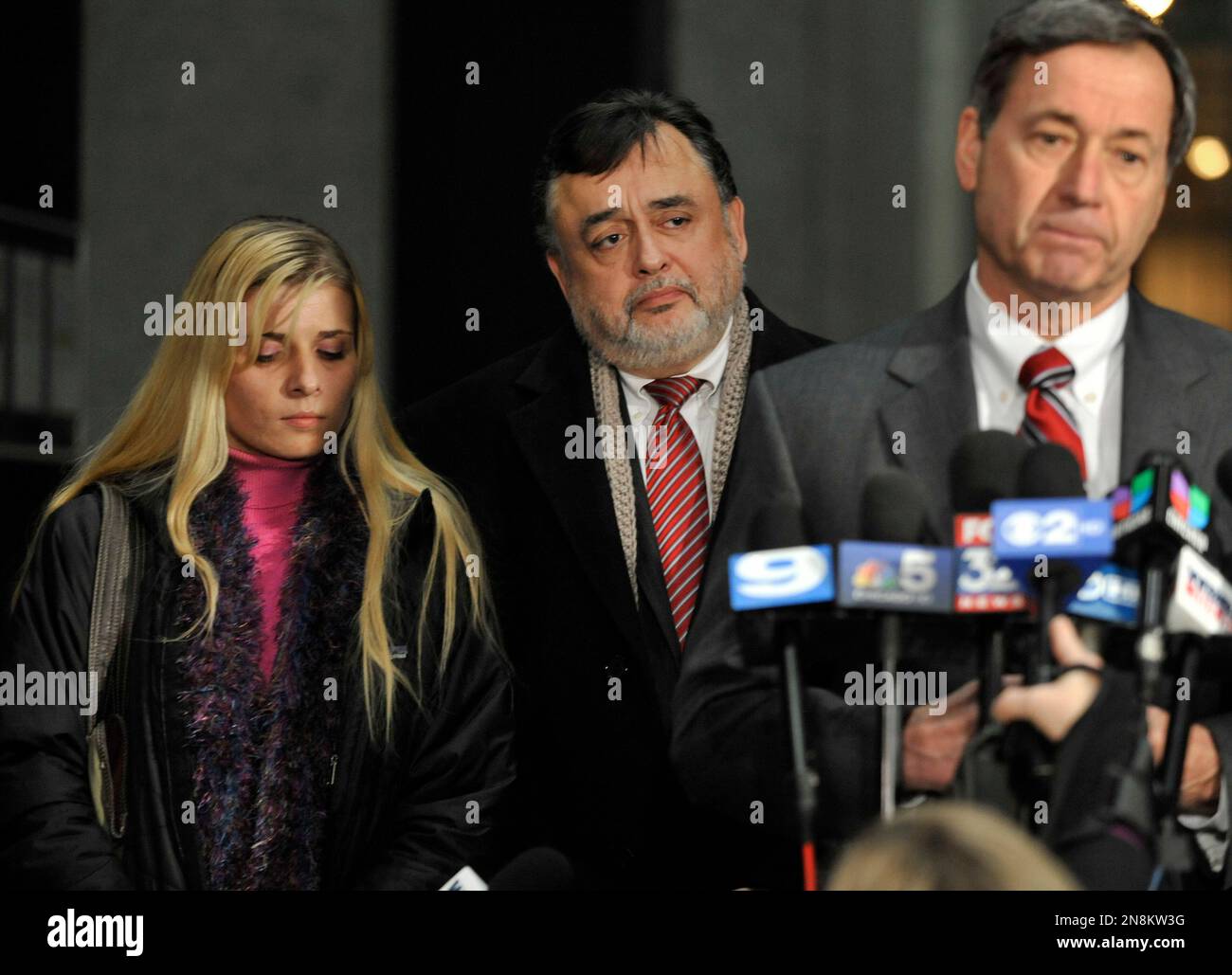 Bartender Karolina Obrycka, left, listens while her attorney Terry Ekl, right, speaks during a news conference in Chicago on Tuesday, Nov. 13, 2012. Jurors awarded $850,000 in damages to Obrycka, who was beaten in February 2007 by off-duty Chicago police officer Anthony Abbate, who was admittedly drunk at the time. Surveillance video of the hulking Abbate pushing Obrycka to the ground behind the bar at Jesse's Shortstop Inn, then repeatedly punching and kicking her went viral online. (AP Photo/Paul Beaty) Stock Photo