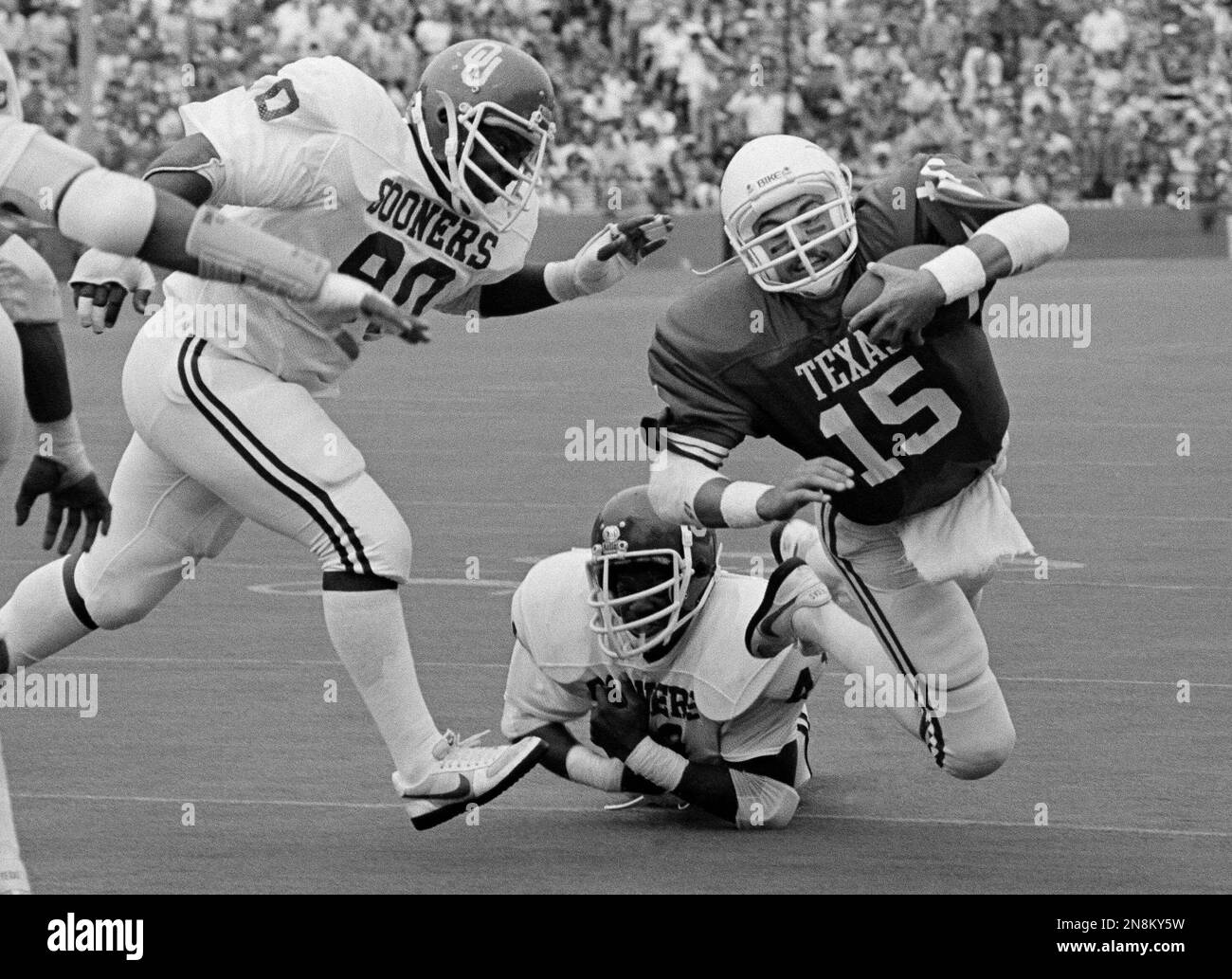 Texas quarterback Rick McIvor falls forward for yardage after being hit