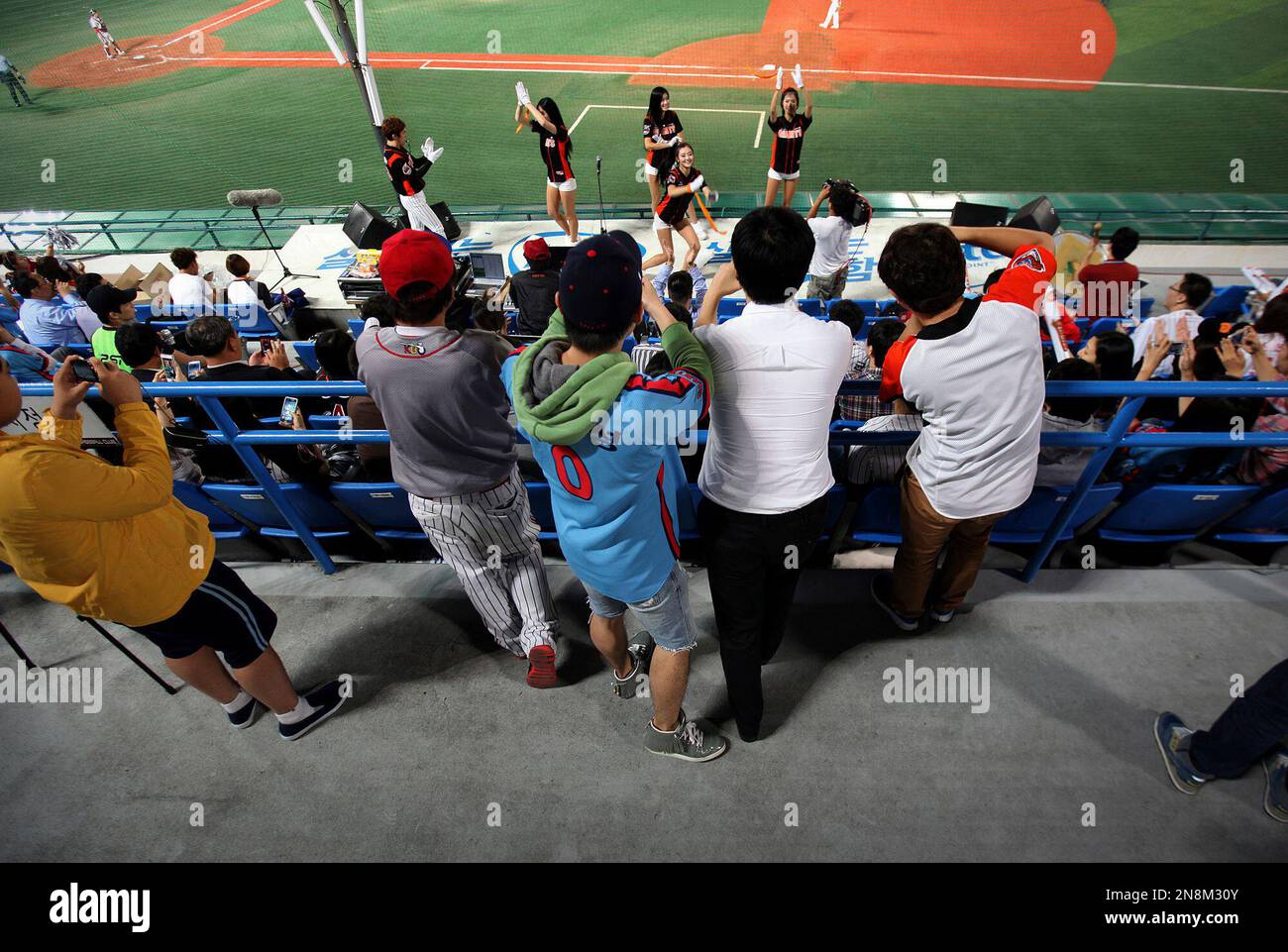 In this Sept. 20, 2012 photo, baseball fans gather to take photographs