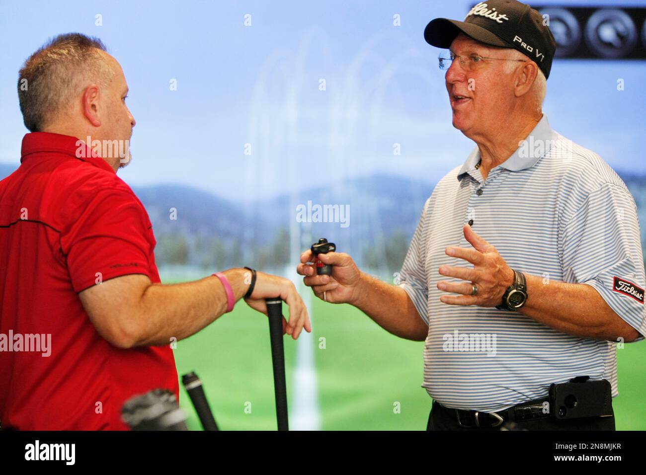 Titleist tech rep Larry Negri, right, goes over proper technique with Golf Galaxy customer David
