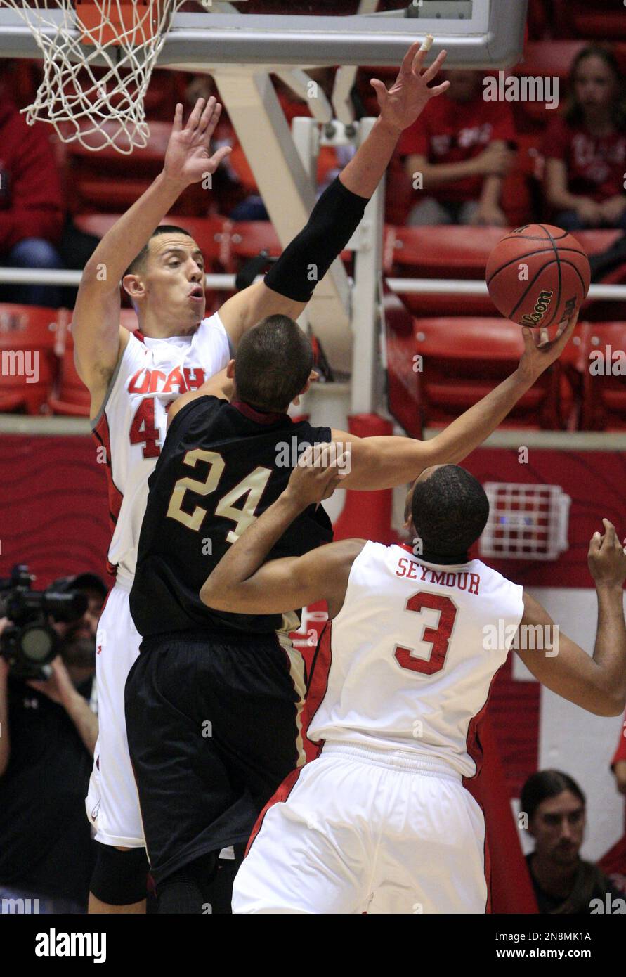 Willamette's Avery Manu (24) shoots as Utah's Jason Washburn (42) and