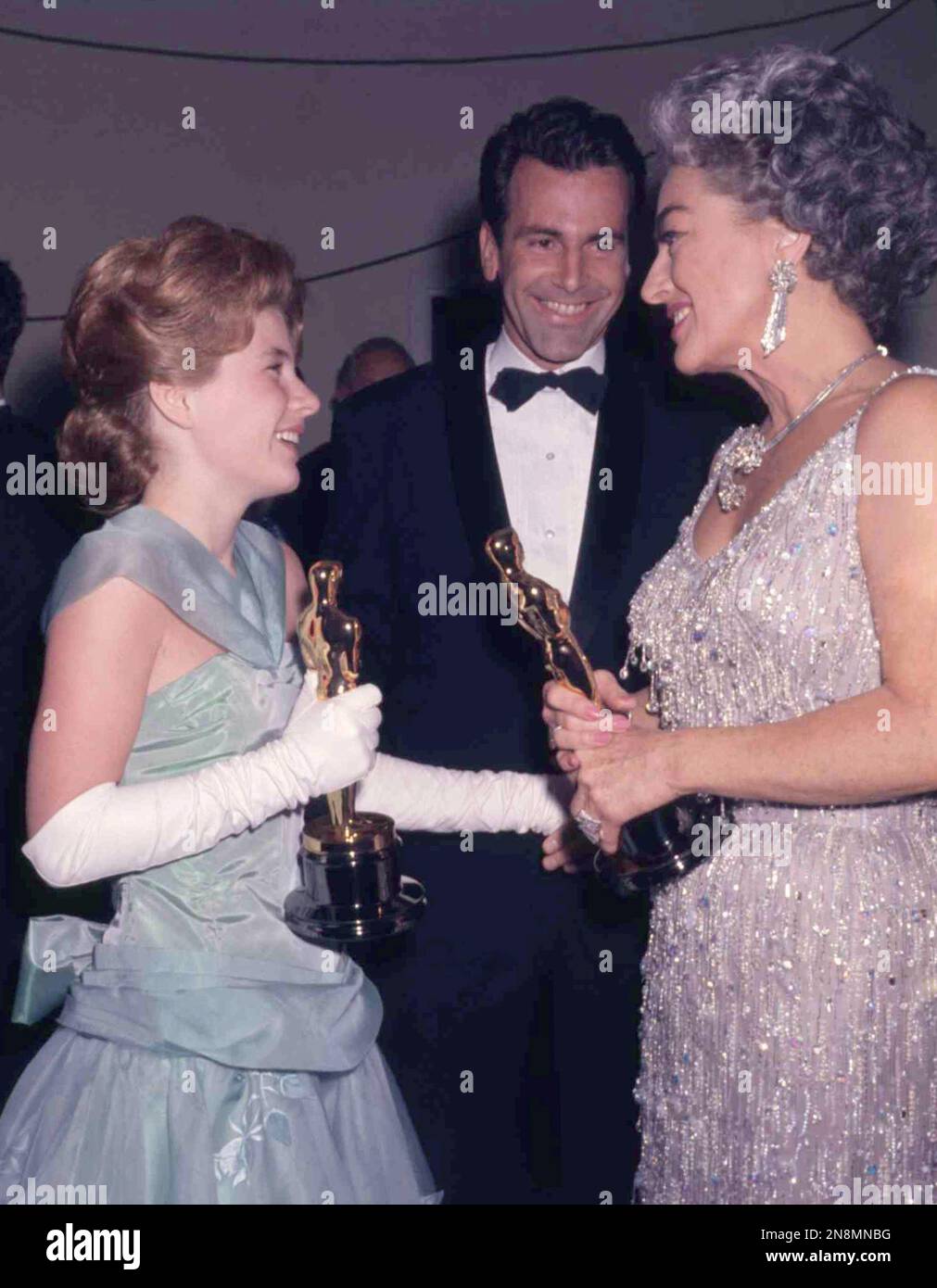 American actress Patty Duke, left, holds her Oscar while talking with ...