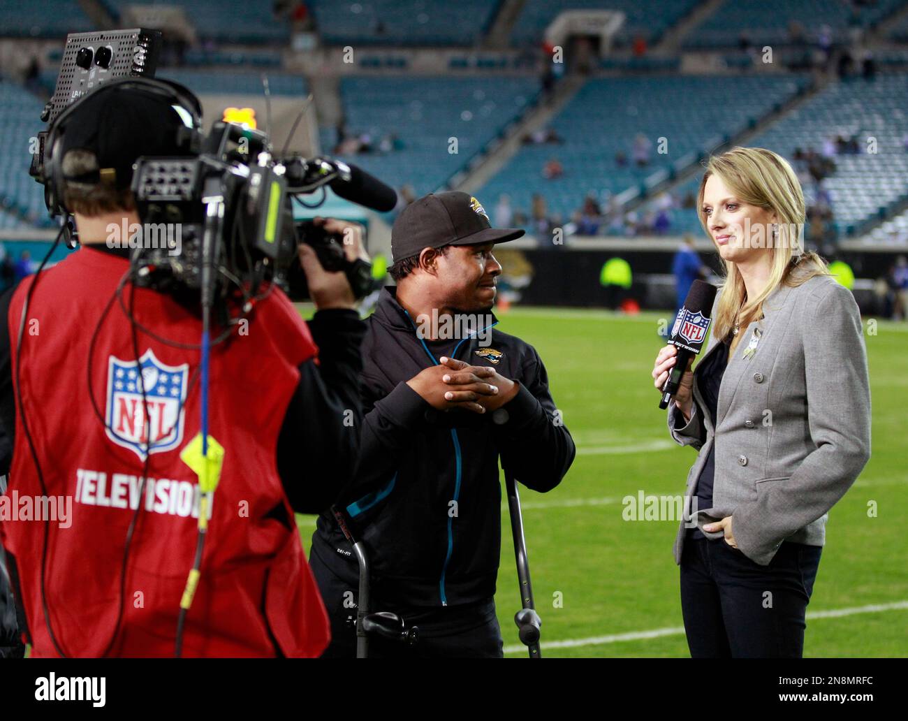 NFL Network reporter Stacey Dales works from the sideline before an NFL  football game between the New Orleans Saints and the Green Bay Packers,  Sunday, Sept. 12, 2021, in Jacksonville, Fla. (AP