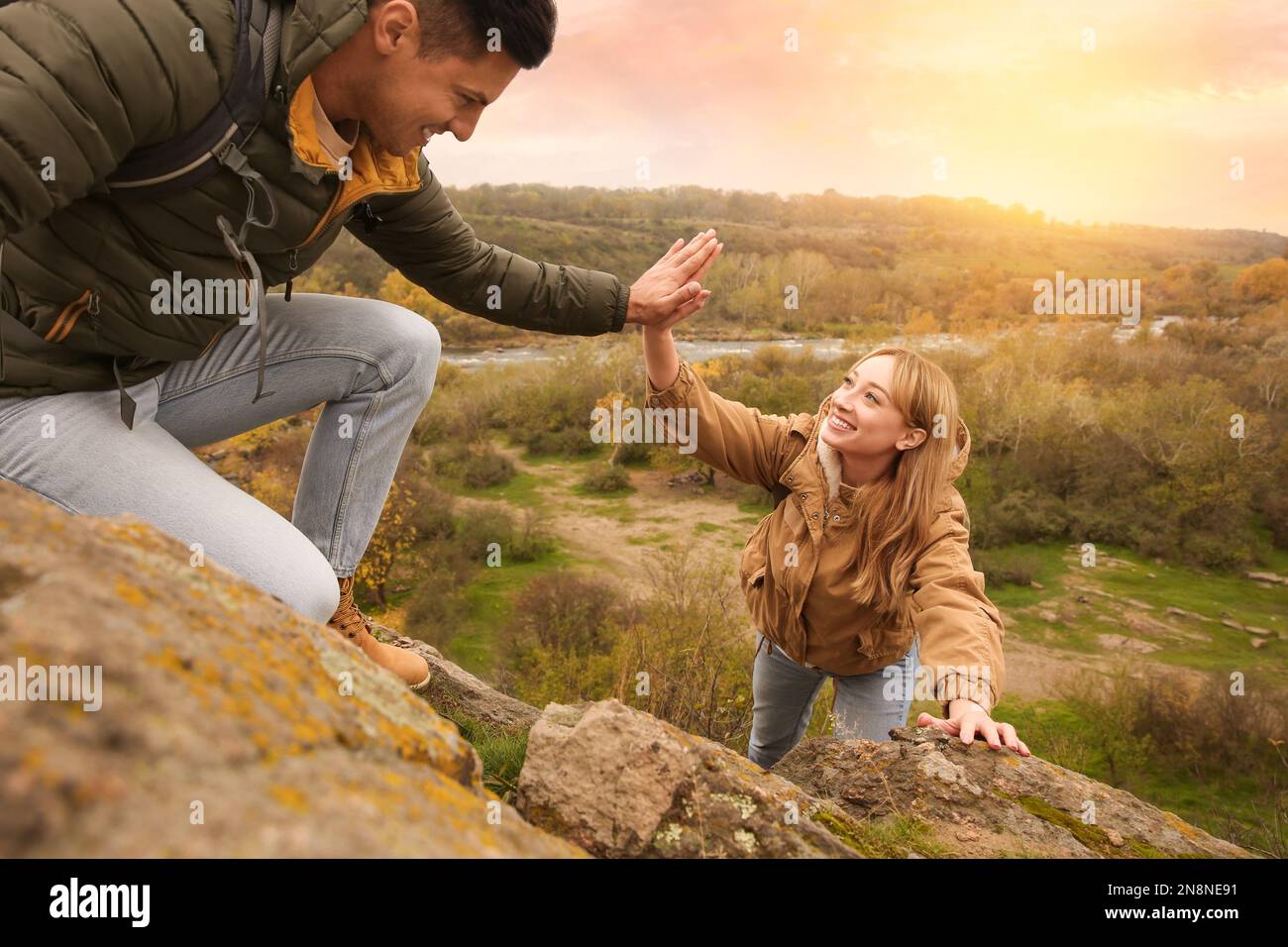 Group of hikers with backpacks climbing up mountains Stock Photo - Alamy