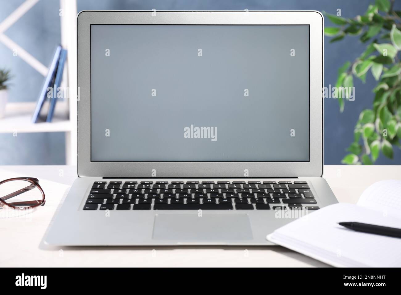 Modern laptop with blank screen on office table Stock Photo - Alamy