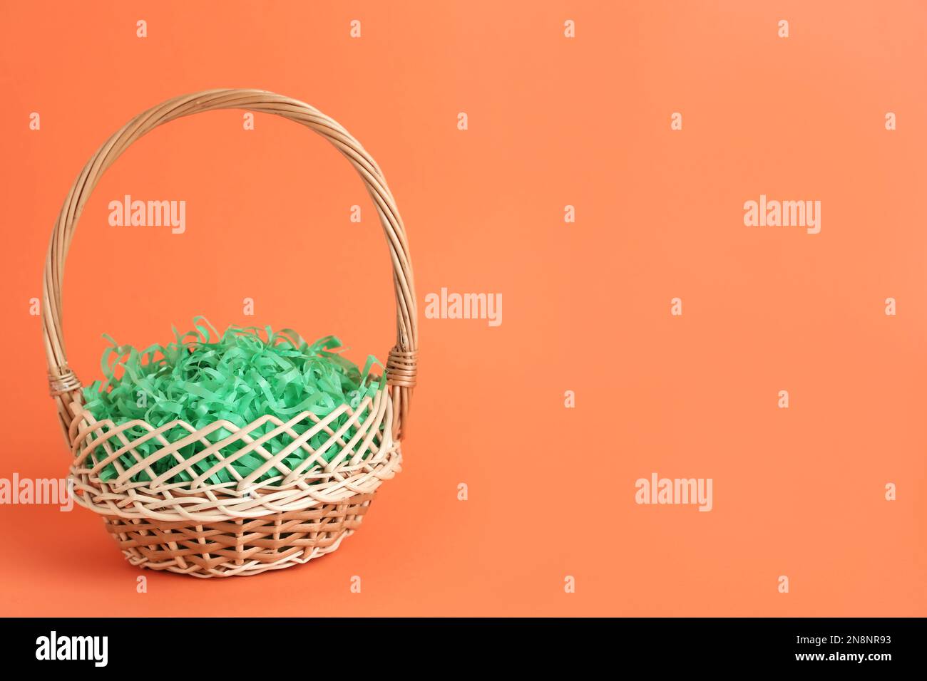 Easter basket with green paper filler isolated on white Stock Photo - Alamy