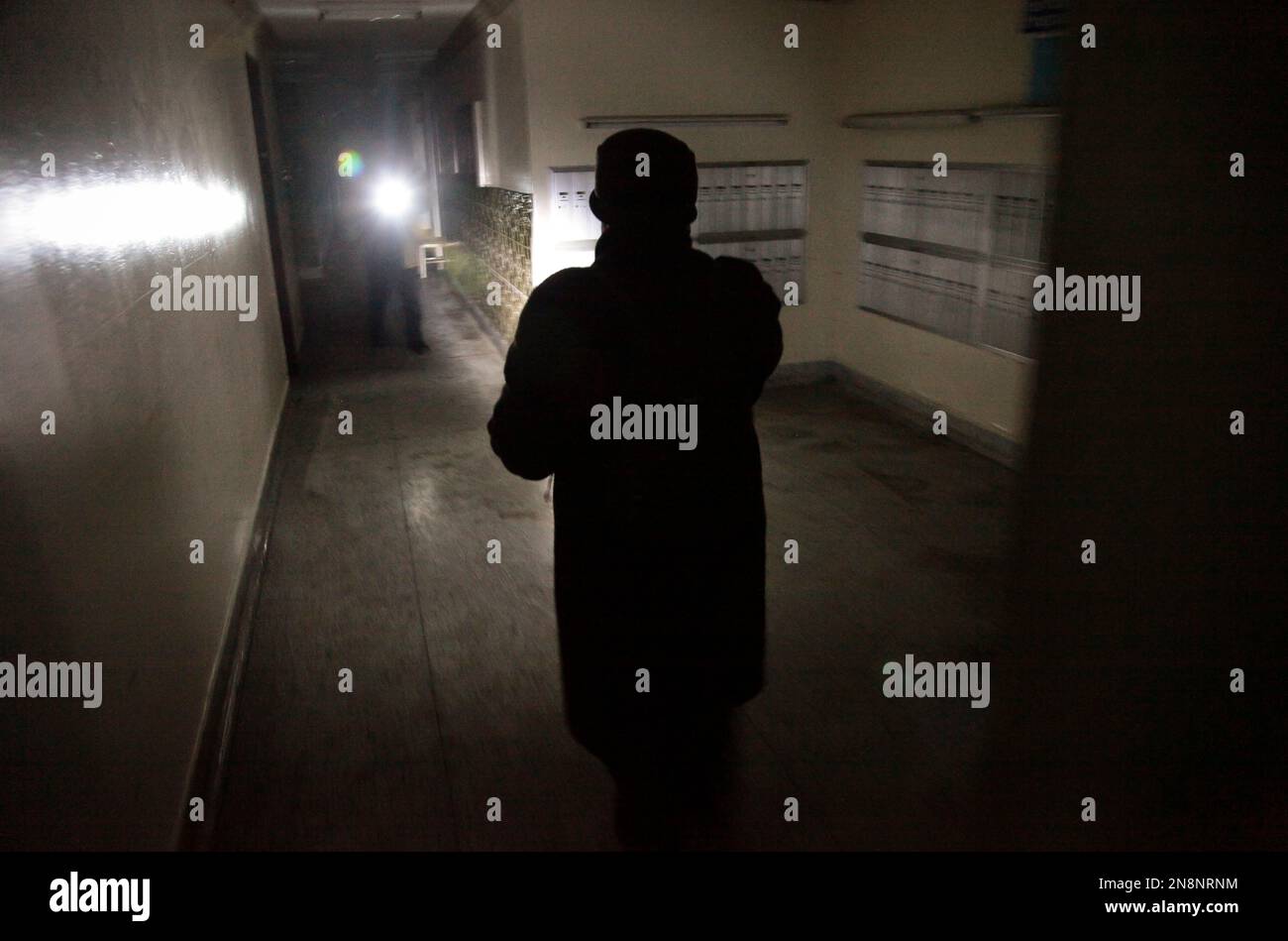 Roxanne Boothe, right, use a flashlight as she walks a hallway at Sam ...
