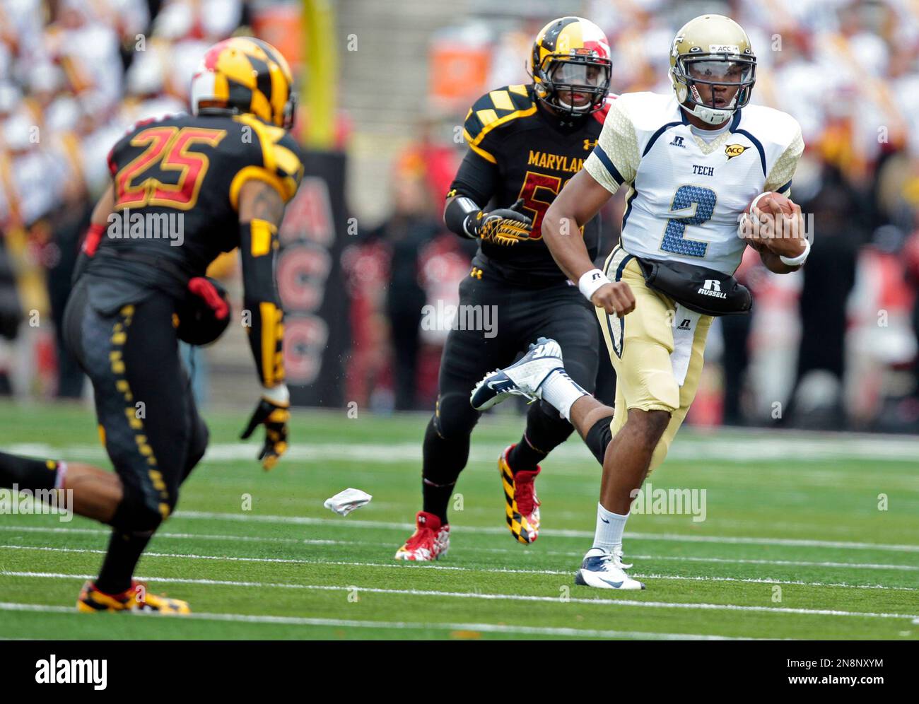 Georgia Tech quarterback Vad Lee (2) runs the ball as Maryland defensive  back Dexter McDougle (25) and linebacker Darin Drakeford (52) defend during  the first half of an NCAA college football game,