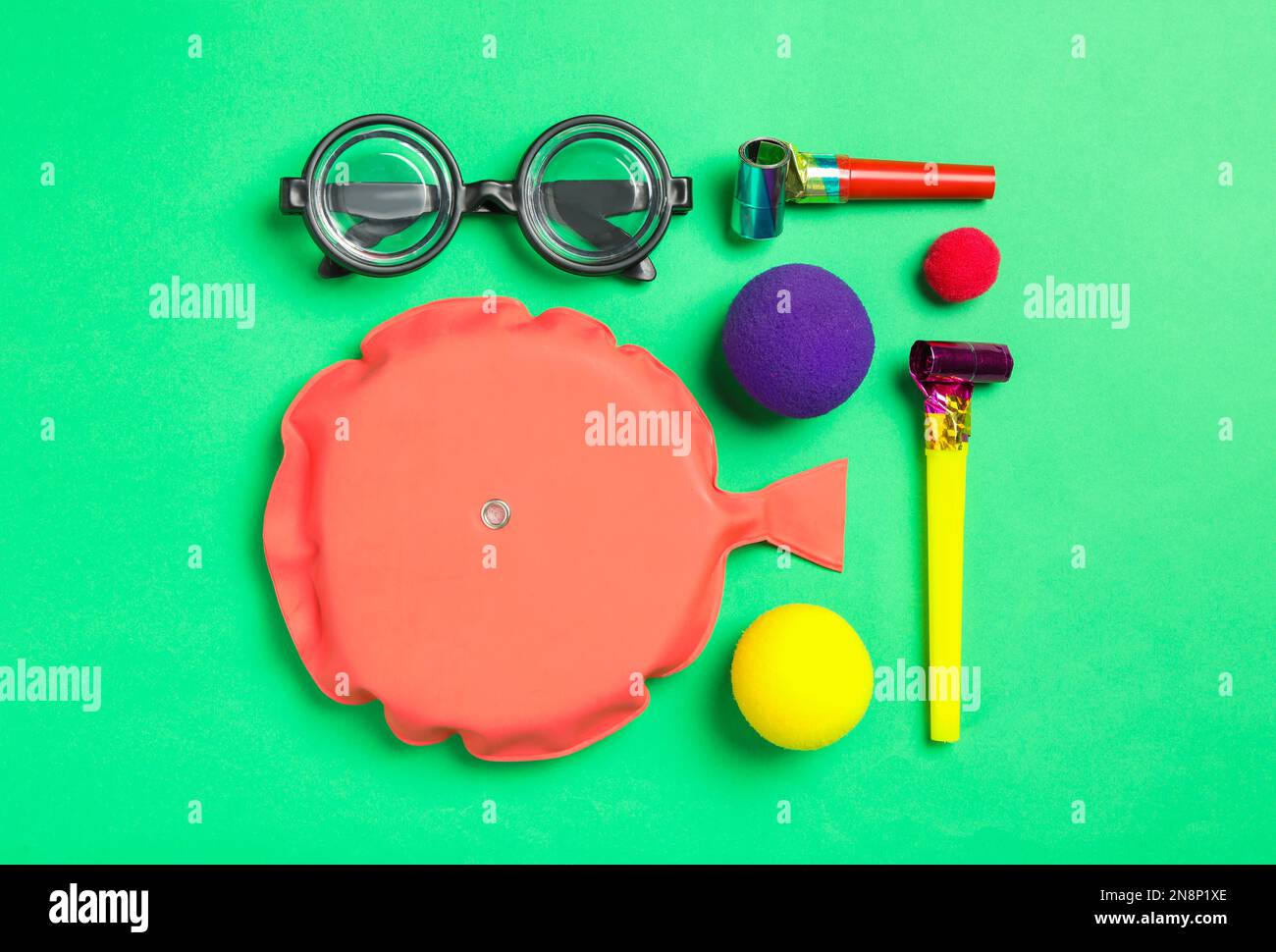 Different clown's accessories on green background, flat lay Stock Photo