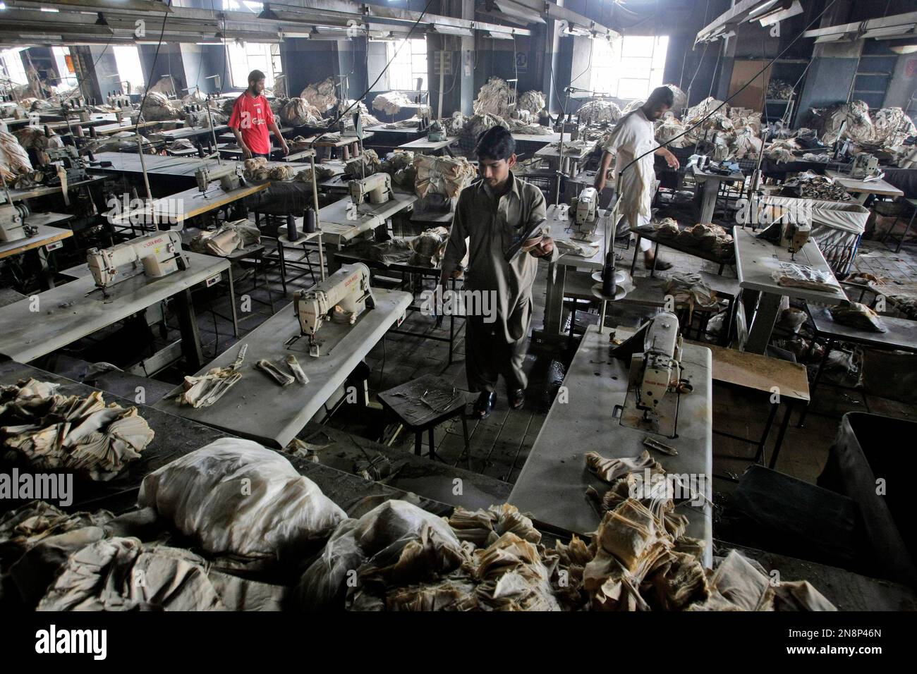 In this Thursday, Sept. 13, 2012 photo, Pakistani men check a burnt