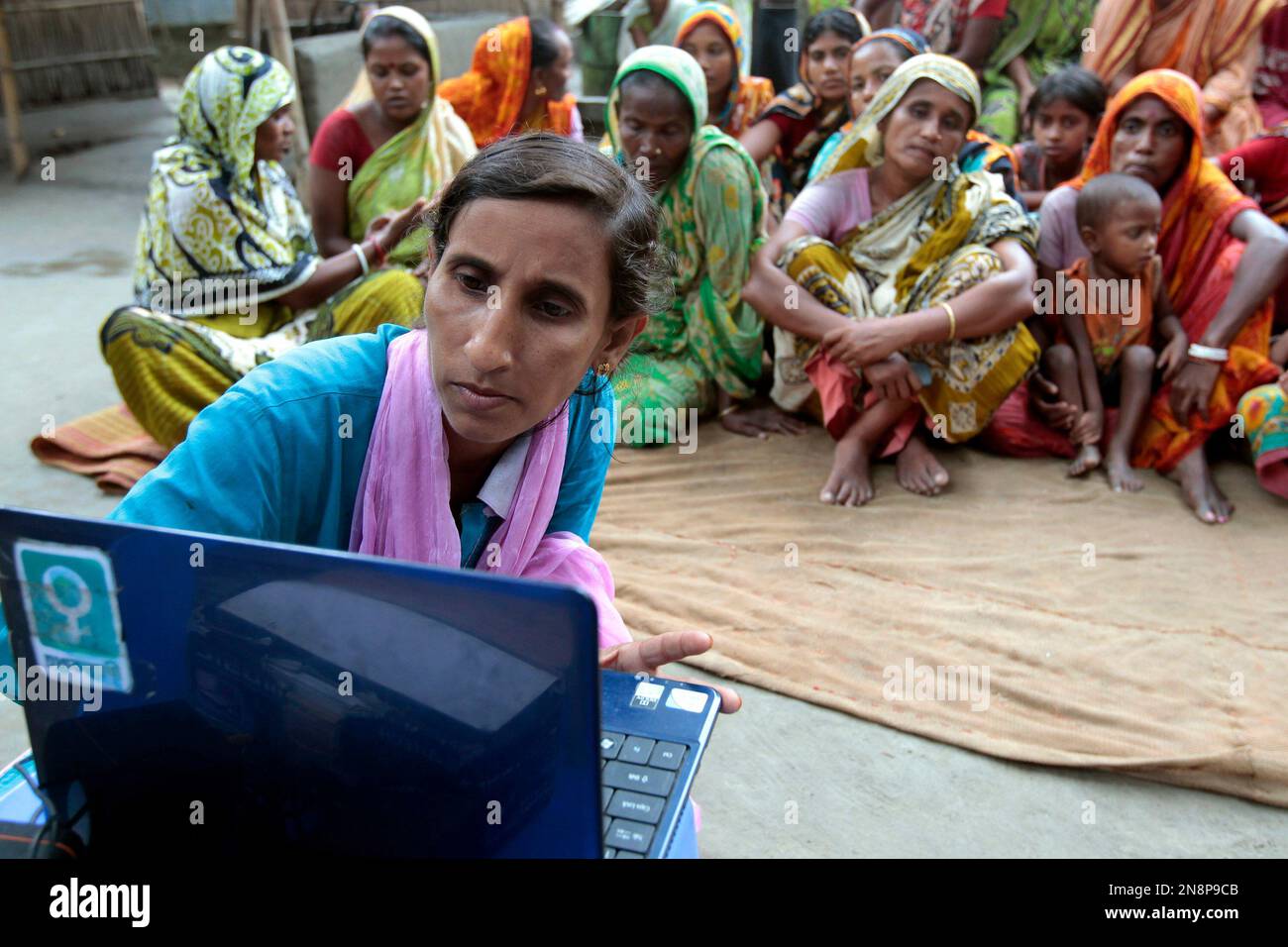 In this Sept. 30, 2012 photo, Sathi Akhtar, a 29-year-old Bangladeshi woman  known as Tattahakallayani or Info Lady shows a 15-minute video played in a  laptop at one of their usual weekly