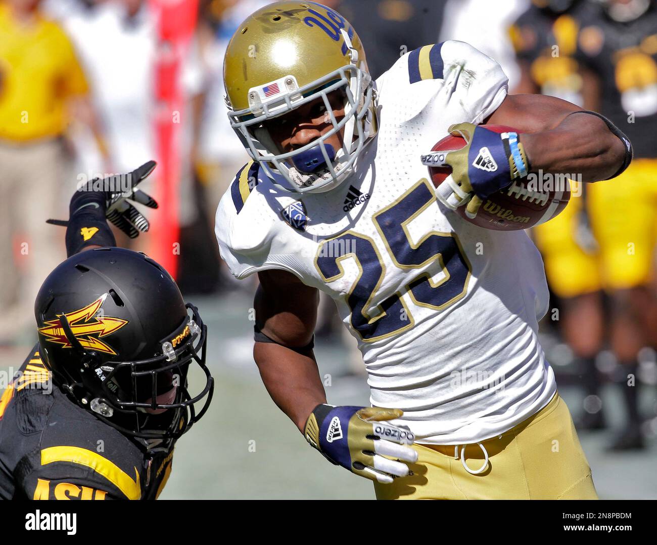 UCLA wide receiver Damien Thigpen (25) pulls in a pass to score a touchdown  as Arizona State safety Alden Darby defends during the second half of an  NCAA College football game, Saturday,, image size:1300x1077