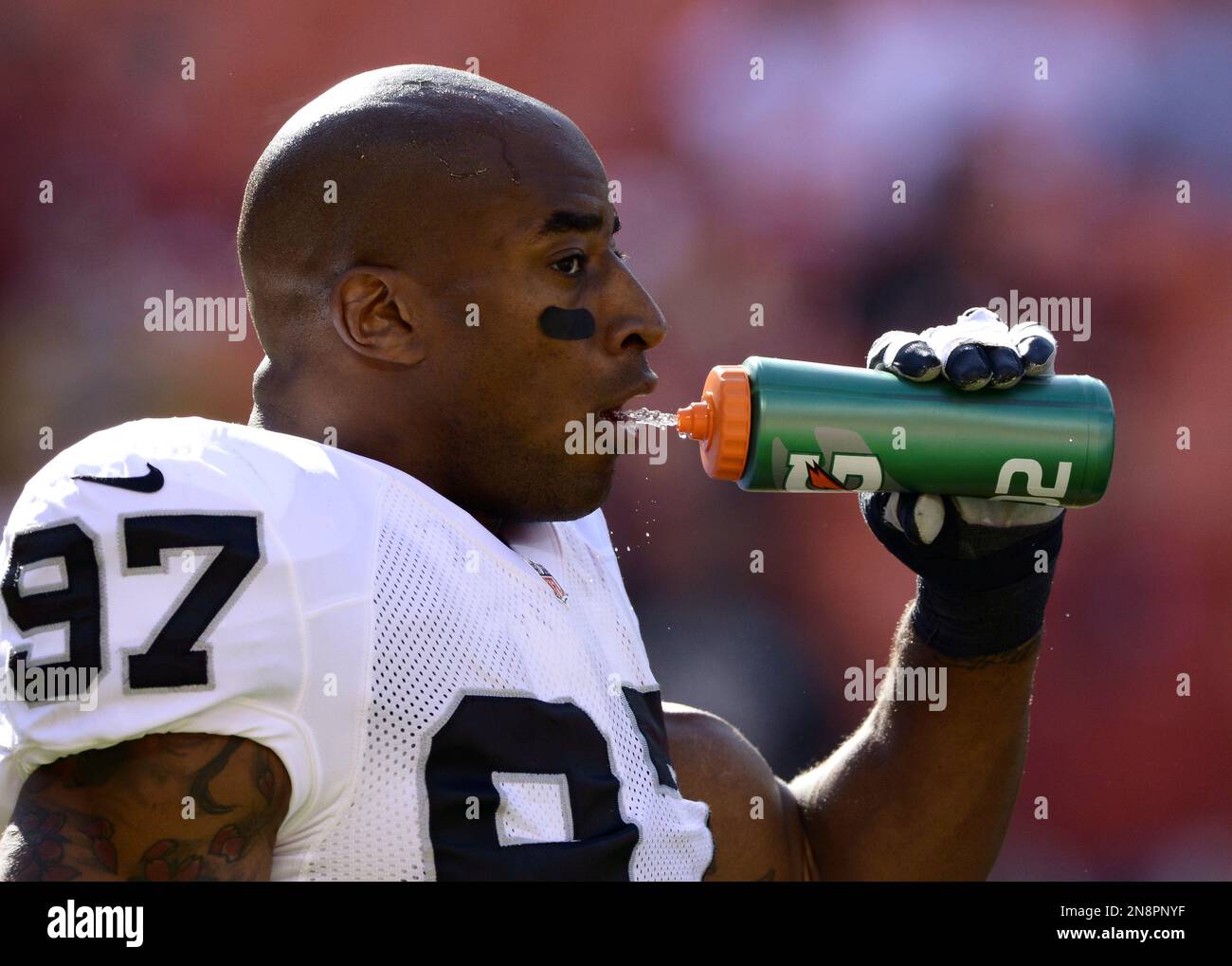 Oakland Raiders defensive end Andre Carter (97) takes some water during the  pre-game to an NFL football game in Kansas City, Mo., Sunday, Oct. 28,  2012. (AP Photo/Reed Hoffmann Stock Photo - Alamy