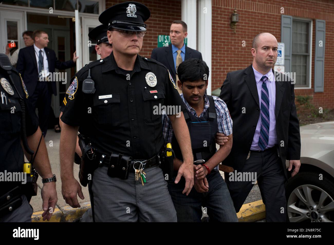 Raghunandan Yandamuri is escorted from a Montgomery County district court after an arraignment Friday, Oct. 26, 2012, in Bridgeport, Pa. Investigators said Yandamuri killed 10-month-old Saanvi Venna and her grandmother Satyavathi Venna in a botched ransom kidnapping. He is being held without bail on murder, kidnapping and other charges. (AP Photo/Matt Rourke) Stock Photo