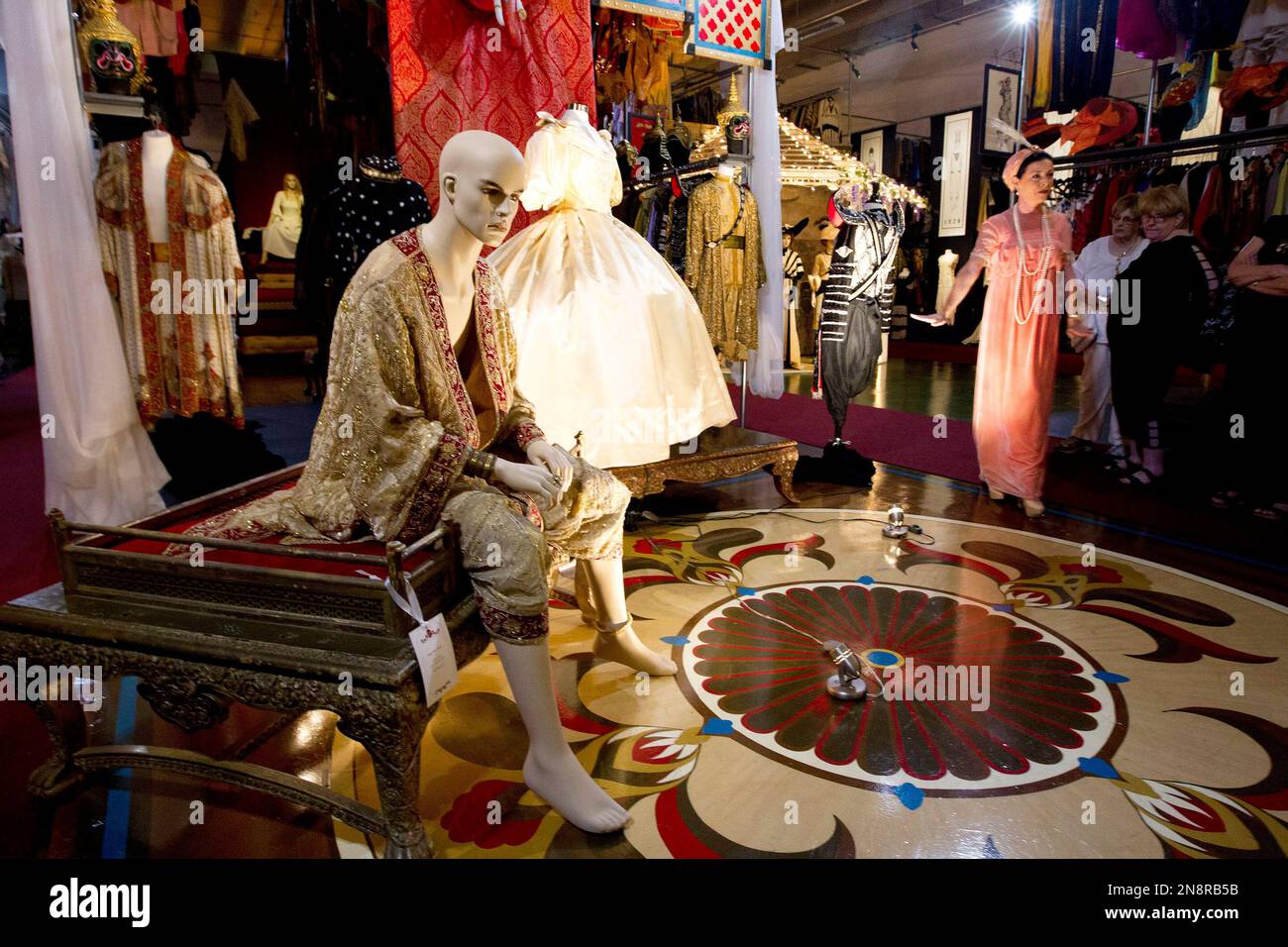 This Oct, 3, 2012 photo shows Kimberly Wick, far right, wearing a flowing, peach gown from the