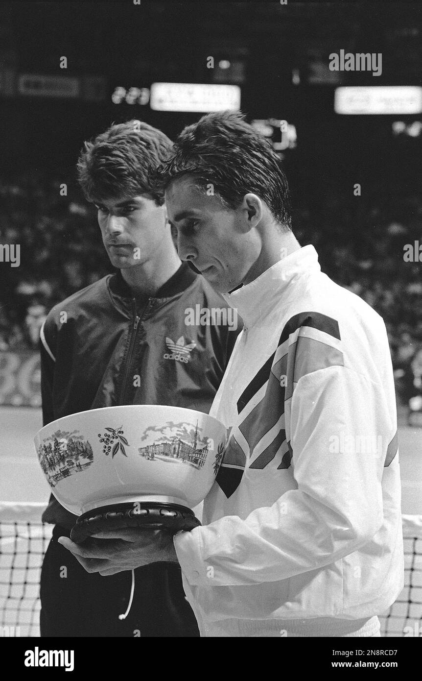 Ivan Lendl, right, holds the victory trophy after winning the U.S. Pro  Indoor Tennis Championships in Philadelphia, Feb. 3, 1986. Lendl was to  play Tim Mayotte, rear, in the final, but Mayotte