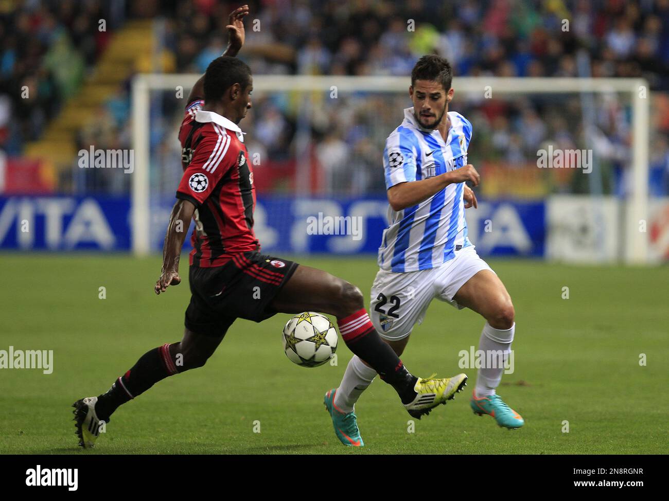 Malaga's Isco Alarcon, right, and AC Milan's Kevin Constant, left