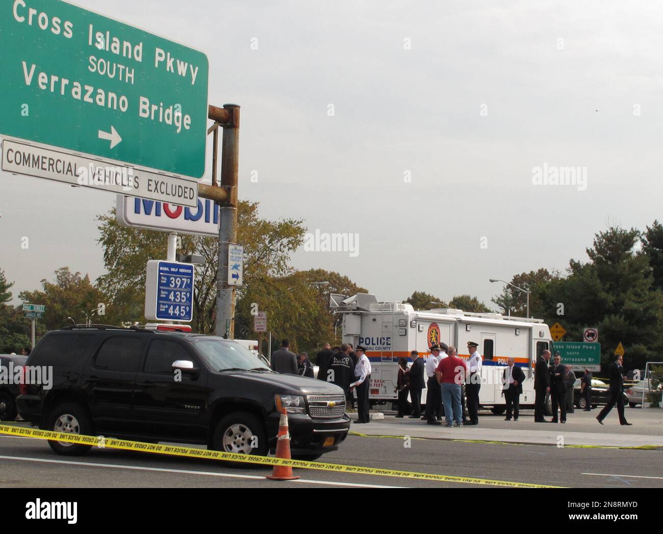 Police officers investigate at the scene of a shooting in Bellerose