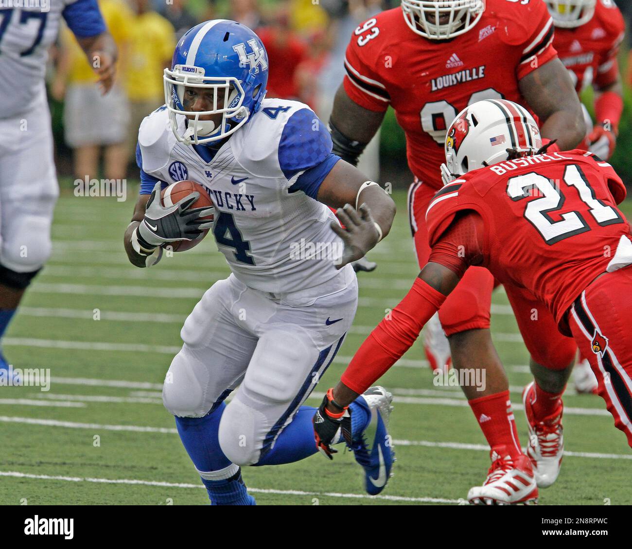 Kentucky tailback Raymond Sanders (4) tries to ward off Louisville's