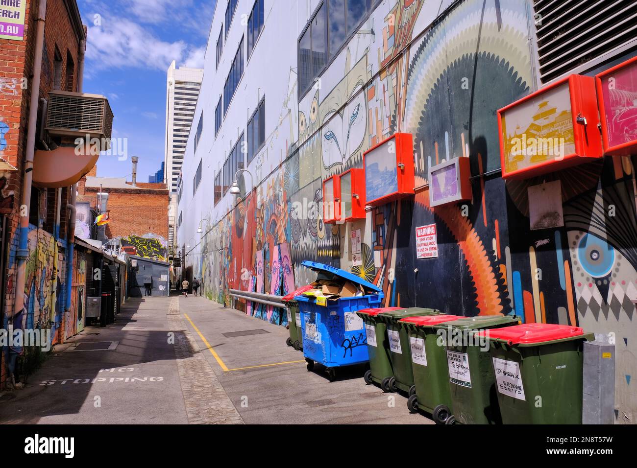 Perth: Street art and rubbish bins along Grand Lane with view to view to high-rise buildings in Perth central business district, Western Australia Stock Photo