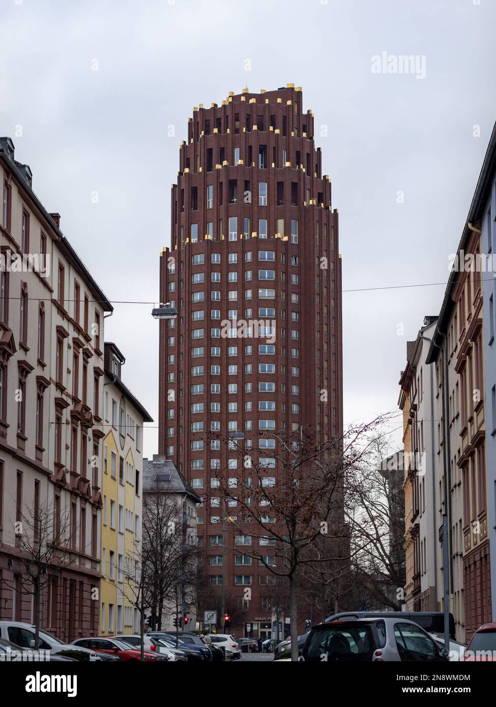 Main Plaza building viewed from the street 'Wasserweg'. High rise building at the end of a road with residential buildings. Architecture by Kollhoff. Stock Photo