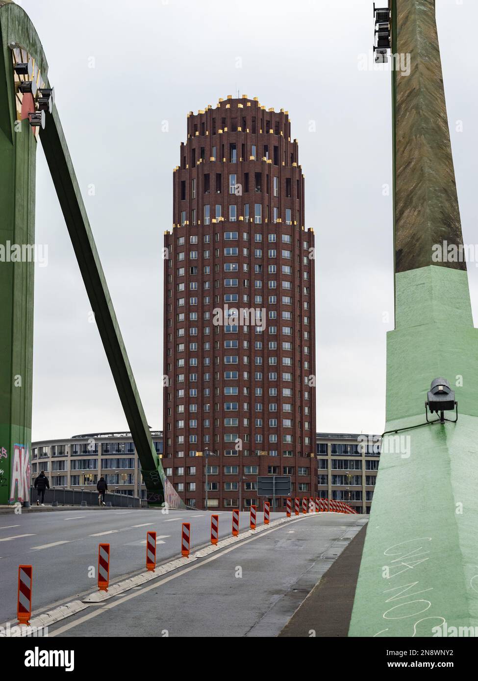 Main Plaza tower building viewed from the bridge 'Flößerbrücke'. High rise landmark with a red brick wall facade. Skyscraper in the southern part . Stock Photo