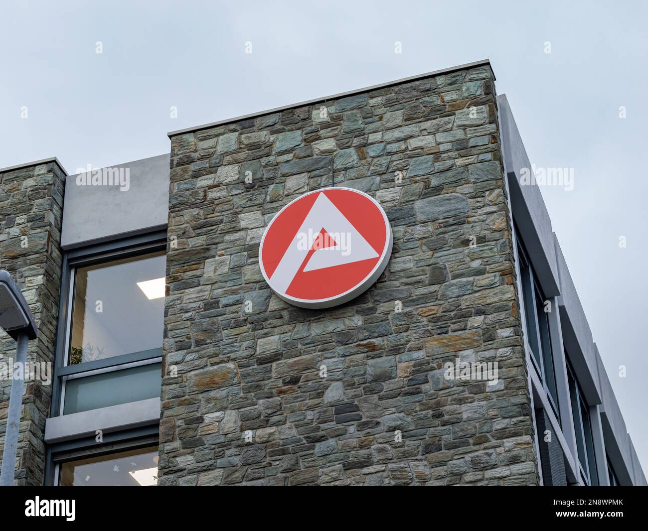 Bundesagentur für Arbeit logo on an office building. The German employment agency sign is the white letter A in a red circle. The Jobcenter logo. Stock Photo