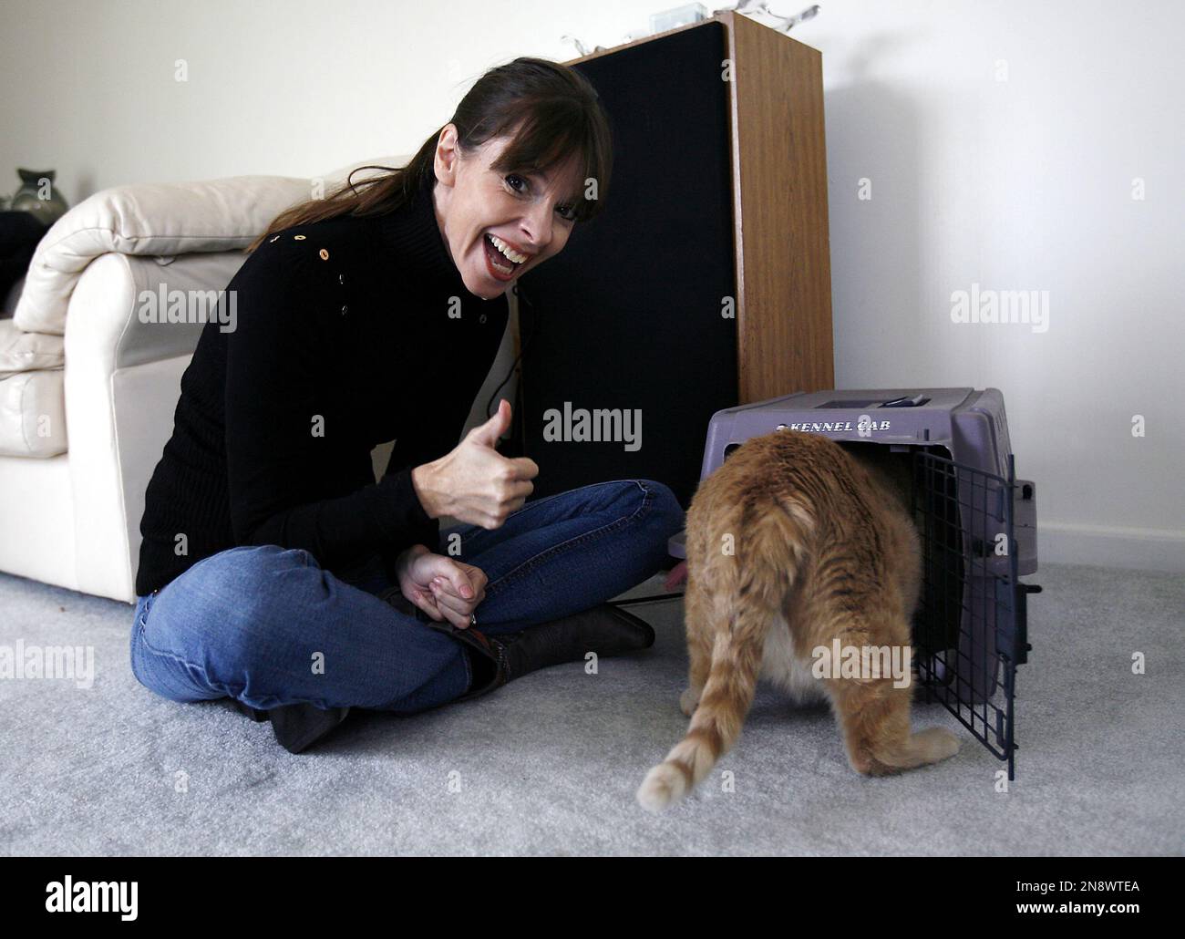 IMAGE DISTRIBUTED FOR BANFIELD PET HOSPITAL - ANIMAL PLANET pet trainer  Victoria Stilwell reacts after Danielle DeLozier's cat Pooh enters the cat  carrier successfully during an in-home training session on Wednesday, Oct.