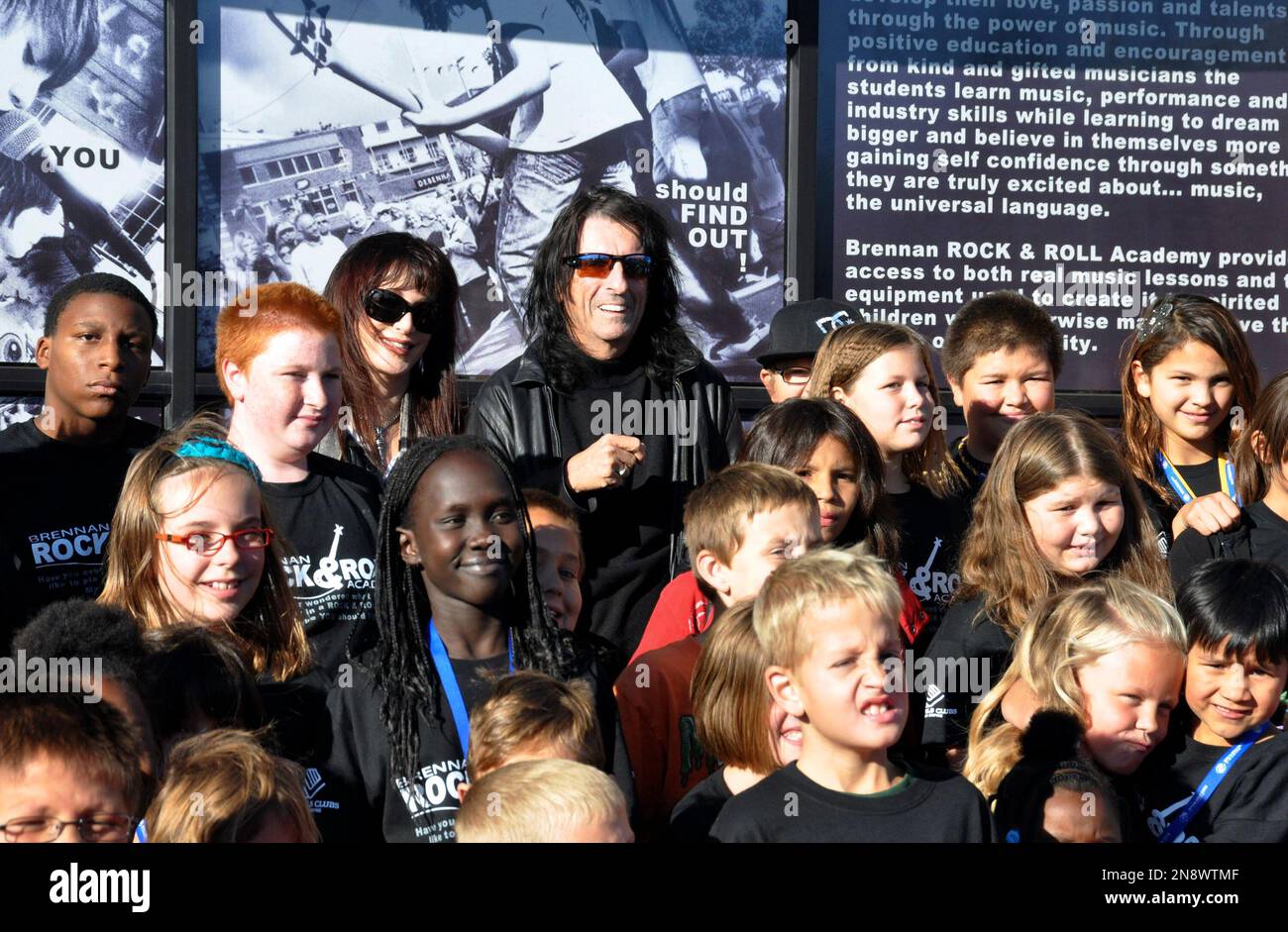 Heavy metal icon Alice Cooper, rear center right, and his wife, Sheryl, rear center left, pose with members of the Boys & Girls Clubs of the Sioux Empire, Wednesday, Oct. 10, 2012, in Sioux Falls, S.D. Cooper was in South Dakota to help his friend, Dollar Loan Center majority owner Chuck Brennan, open a 6,000-square-foot rock ëní roll academy that will be open exclusively to club members. (AP Photo/Dirk Lammers) Stock Photo