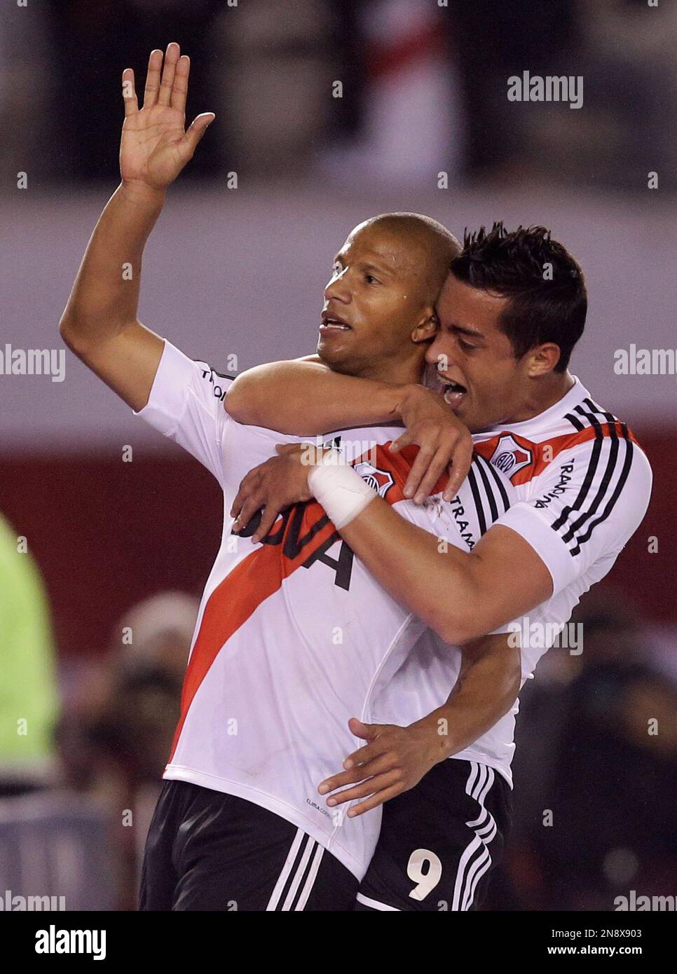 River Plate's Carlos Sanchez, left, celebrates with teammate Gabriel Funes  Mori, right, after scoring against Godoy Cruz during an Argentina's league  soccer match in Buenos Aires, Argentina, Sunday, Oct. 7, 2012. (AP
